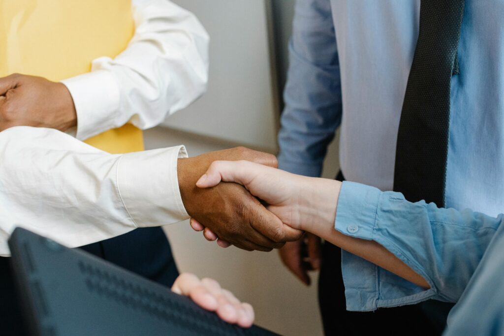 Two people shaking hands at work.