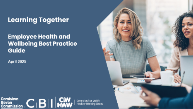 People sitting at a table with a computer and talking. Learning Together. Employee health and wellbeing best practice guide. April 2025 